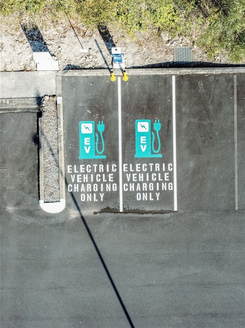 Birds-eye view of two electric vehicle charging stations in the Slim Dusty Centre carpark.