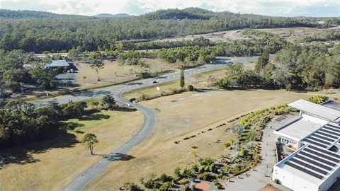 A landscape drone image looking over the Slim Dusty Centre gardens, driveway and grounds.